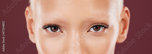 Portrait, woman eyes and beauty makeup with mascara and eyebrows bleached in a studio. Cosmetics, eyebrow treatment and self care for lashes close up of a young model with isolated brown background