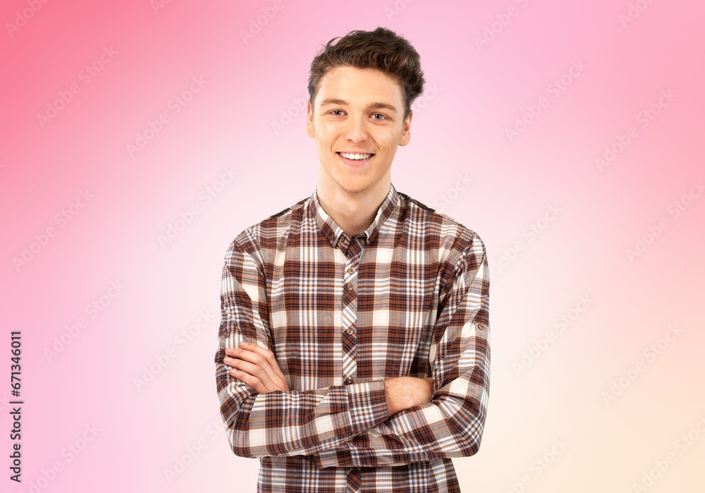 Happy young man standing with crossed arms Happy young man standing with crossed arms