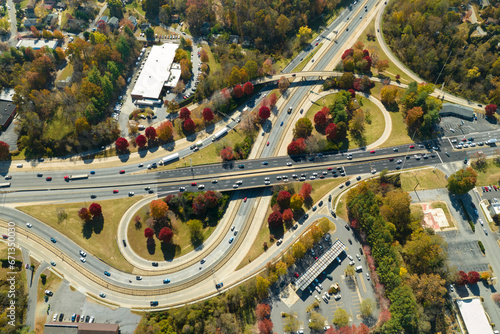 American freeway intersection with fast driving cars and trucks. View from above of USA transportation infrastructure