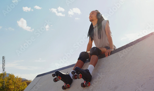 Foto Music, relax and man rollerskating at a park, thinking and sitting in peace in Australia