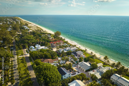 View from above of large residential houses in island small town Boca Grande on Gasparilla Island in southwest Florida. American dream homes as example of real estate development in US suburbs © bilanol