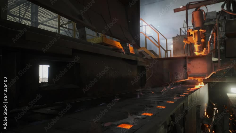 Casting molten steel into molds in the ironworks. Serial production in a heavy industry factory Casting molten steel into molds in the ironworks. Serial production in a heavy industry factory