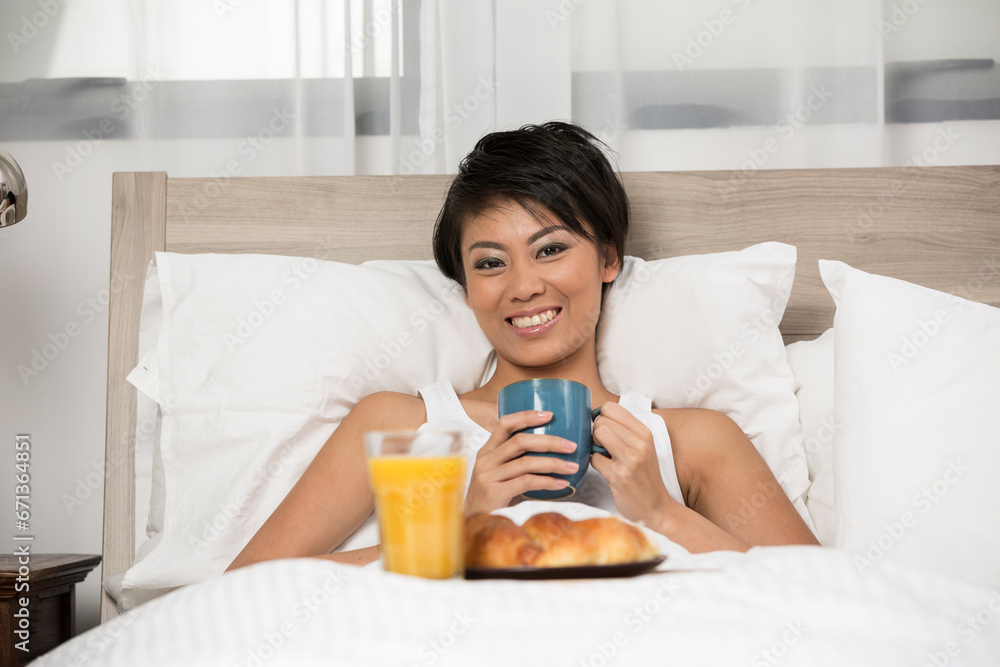 Chinese Woman having breakfast in bed