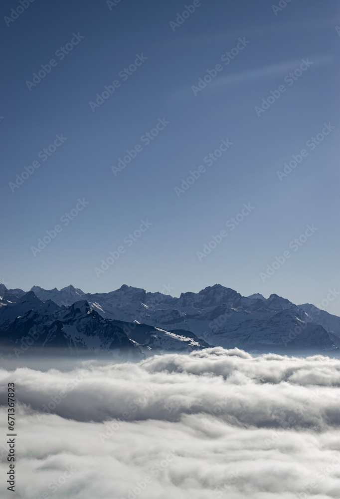 Scenic view of the swiss alps above the fog in winter