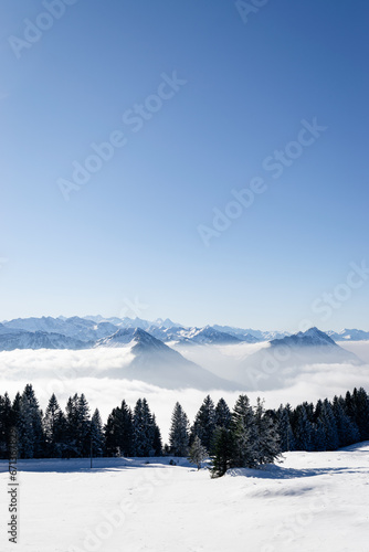 Scenic view of the swiss alps above the fog in winter © stemue_photo