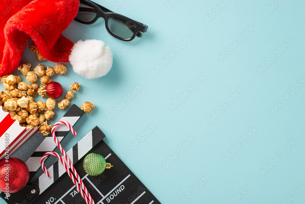 Holiday Movie Night: Top view of a movie clapper, 3D glasses, striped popcorn box, Santa's hat, baubles, thematic candies on a light blue surface with space for advertising