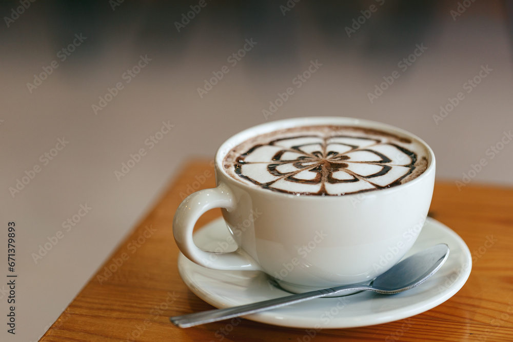 Closeup hot chocolate in a white glass on a table in a restaurant Closeup hot chocolate in a white glass on a table in a restaurant