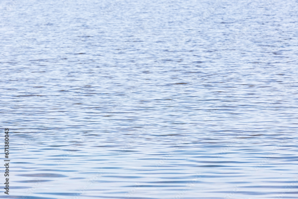 Light blue sea water surface with ripple pattern, natural background Light blue sea water surface with ripple pattern, natural background