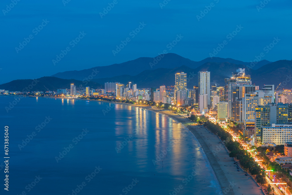 Nha Trang city with buildings and beach view during twilight.
