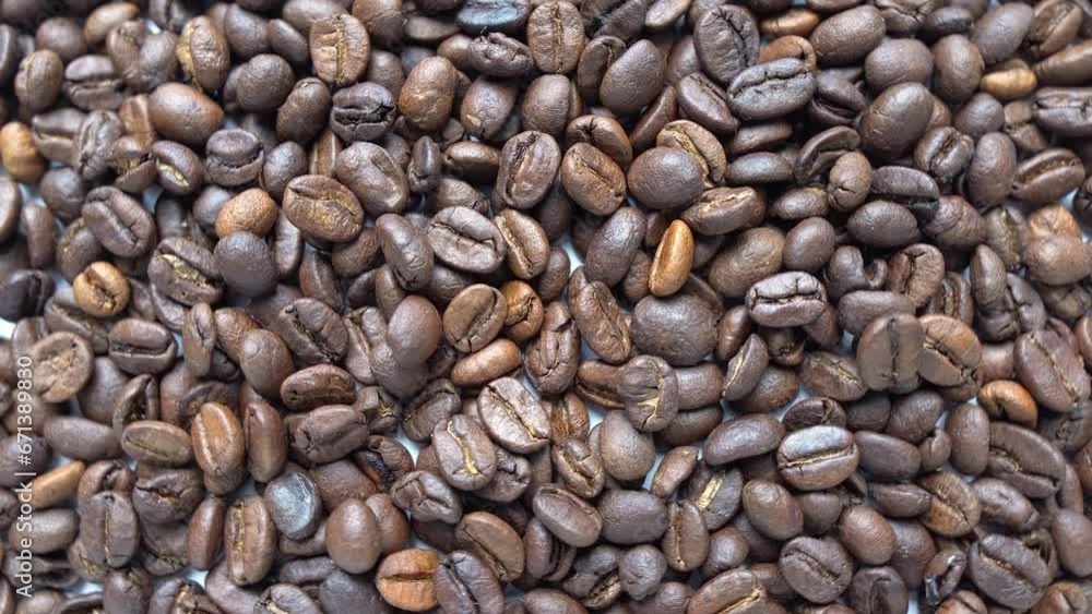 Roasted coffee beans spinning. slow motion. Close up shot. 4k video Roasted coffee beans spinning. slow motion. Close up shot. 4k video