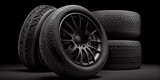 Automotive new black rubber tire wheels on a dark background. AI generated.