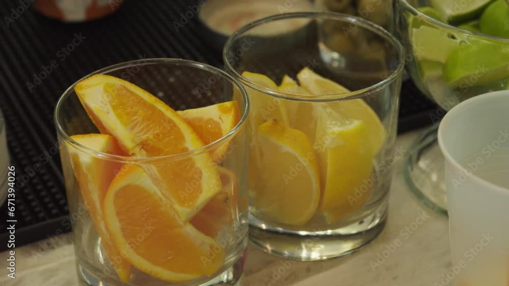 Close-up shot of freshly cut oranges, lemon and limes ready for garnishing drinks Close-up shot of freshly cut oranges, lemon and limes ready for garnishing drinks