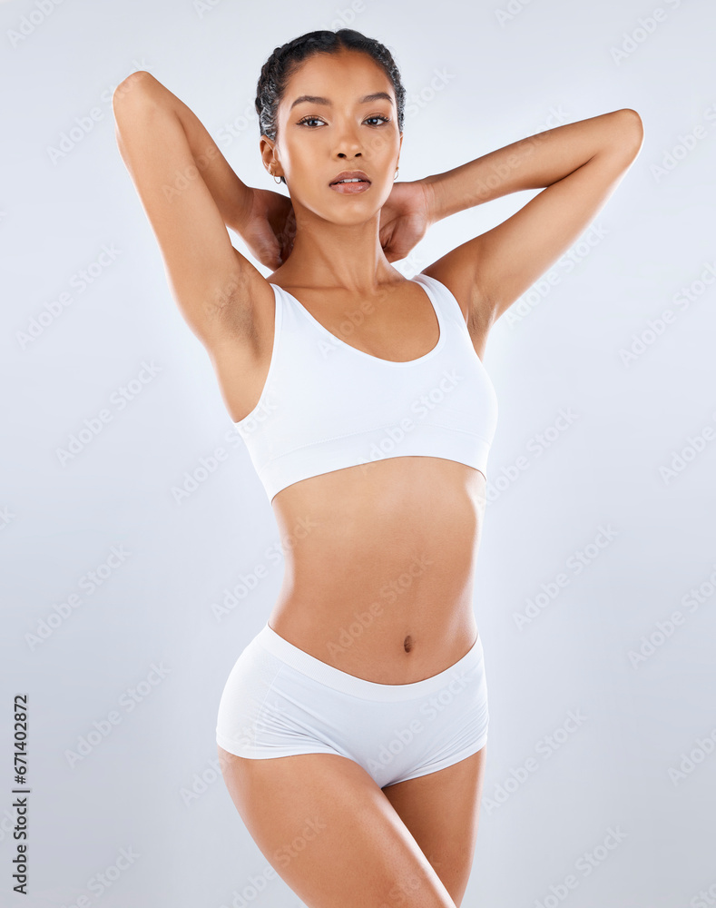 Fototapeta premium Skin, beauty and body care, portrait of woman in underwear with healthy diet, exercise and balance in studio. Fitness, nutrition and skincare, wellness and slim fit figure isolated on grey background