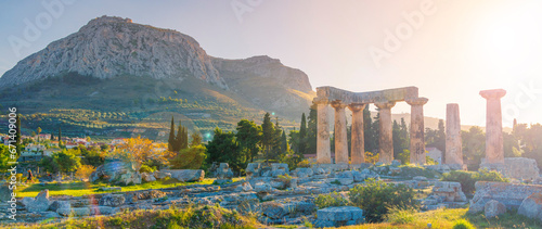 Ruins of temple of Apollo at sunset, Ancient Corinth in Greece photo