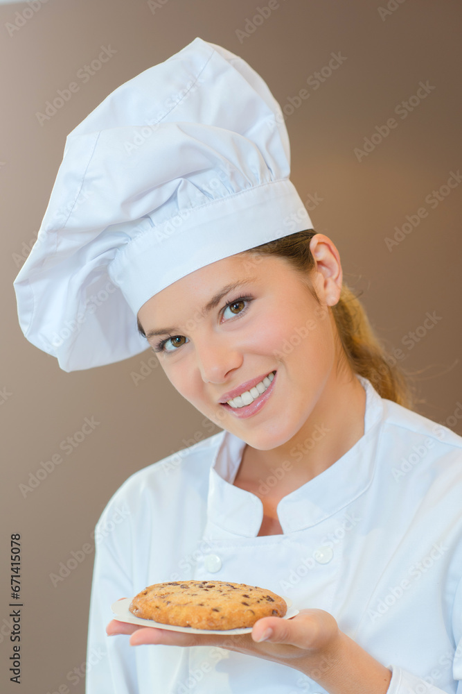 Holding a cookie she's just made Holding a cookie she's just made