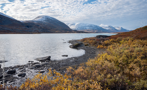 Beautiful Autumn Scenery in the Swedish Lapland with mountains and a lake