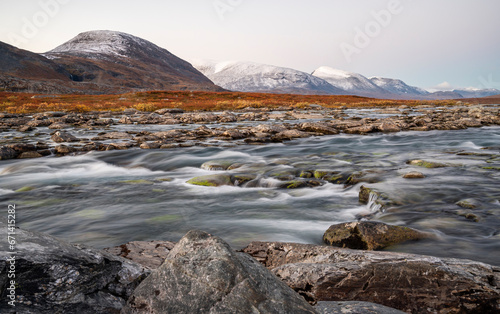 Beautiful Autumn Scenery in the Swedish Lapland with mountains and a river