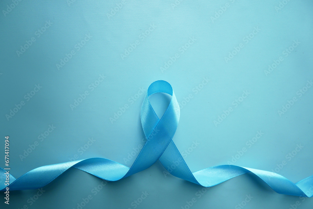 Blue awareness ribbon with the trail on a  blue background with copy space. Prostate Cancer Awareness, child abuse, diabetes.  - obrazy, fototapety, plakaty 