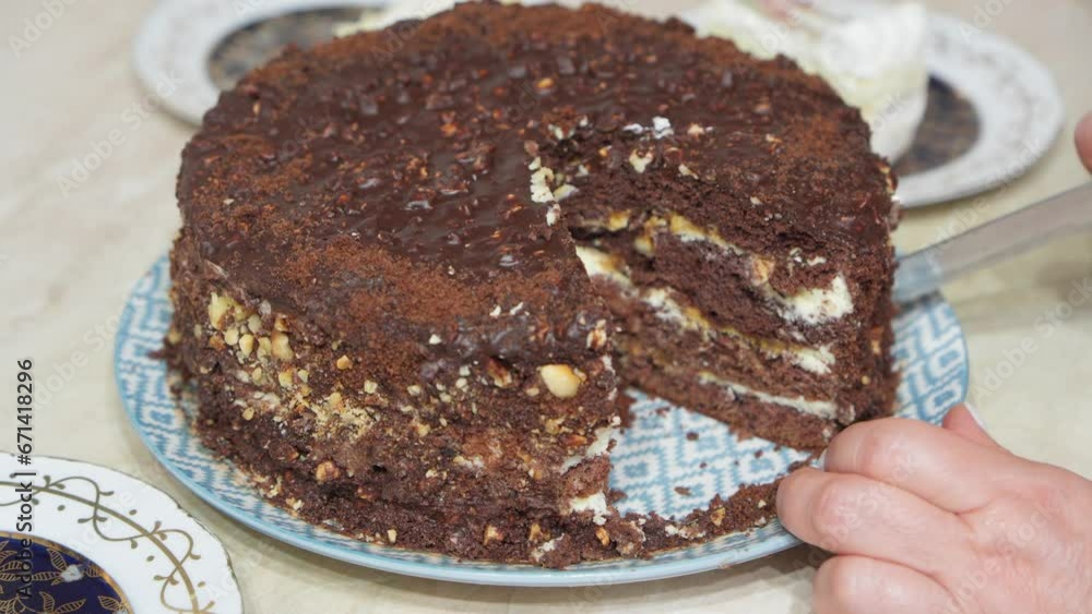 Cutting sweet chocolate cake with kitchen knife. Cutting sweet chocolate cake with kitchen knife.