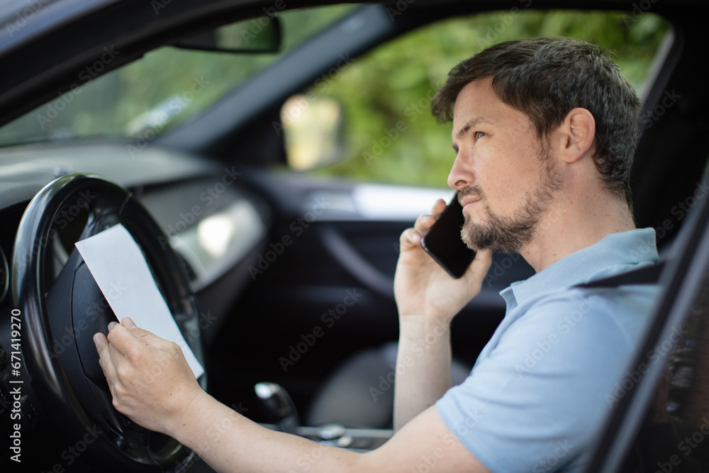 a man at the wheel on a phone call