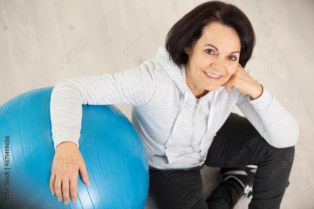happy active mature woman with fitness ball happy active mature woman with fitness ball