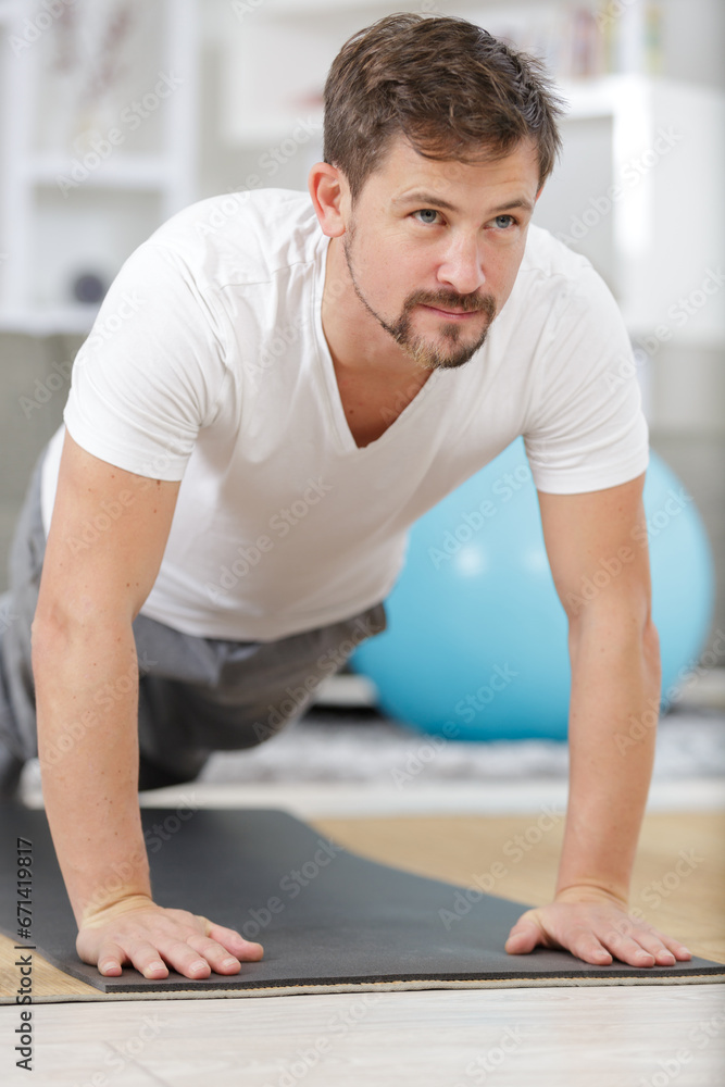 man in plank position exercising at home man in plank position exercising at home