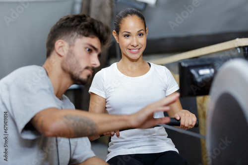 gym instructor giving advice to student