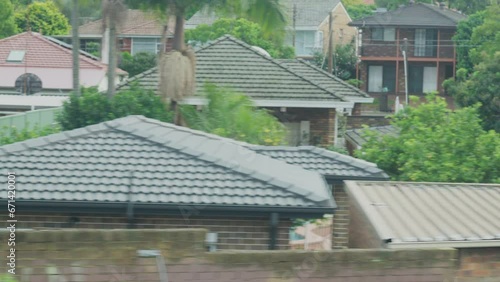 Wallpaper Mural Filming out of a train window during the early dawn passing buildings and backyards in Sydney Australia Torontodigital.ca