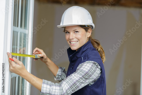 female worker measure the window