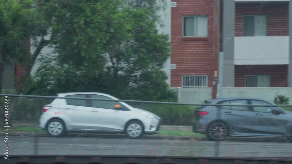 Filming out of a train window during the early dawn passing houses and buildings in Sydney Australia Filming out of a train window during the early dawn passing houses and buildings in Sydney Australia