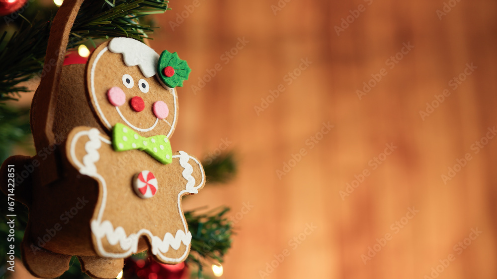 Gingerbread man decoration on a Christmas tree with falling snow Gingerbread man decoration on a Christmas tree with falling snow