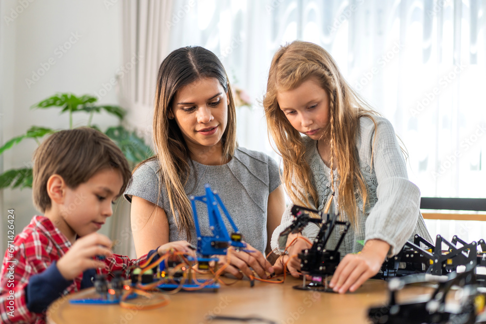Portrait happy teacher help school children student having fun activity learn training play building toy STEM, education, science, engineering, programming, coding, robot technology class at school Portrait happy teacher help school children student having fun activity learn training play building toy STEM, education, science, engineering, programming, coding, robot technology class at school