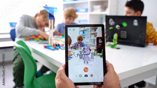 Quiver Augmented Reality for children game. Close up child hands hold digital tablet play with drawing 3d gadget screen in study classroom educational science