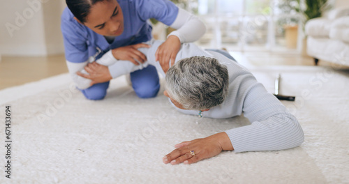 Fall, accident and senior patient with helping in a hospital with injury and caregiver support. Elderly care, emergency and floor with a person in pain with healthcare professional assistance photo