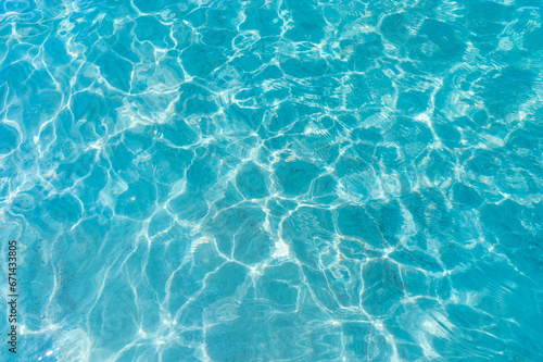 Clear blue turquoise ripple sea water surface. Pure sparkled transparent liquid natural texture background with sunlight reflections
