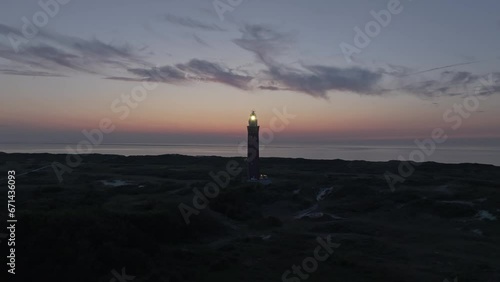 Magical sunset at Lighthouse Westhoofd Ouddorp on coastline, aerial photo