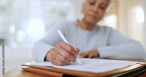 Senior woman, sign and writing with documents, paperwork and application for life insurance policy. Person, hand and checklist for compliance, investment or will in retirement with signature in home photo