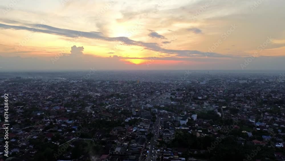Aerial 4k video of Pekanbaru city during sunset. The capital city of Riau province with many residential buildings. Aerial 4k video of Pekanbaru city during sunset. The capital city of Riau province with many residential buildings.