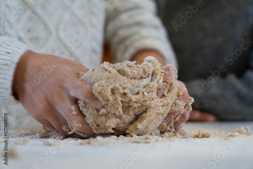 Child's hands kneading a homemade pizza dough