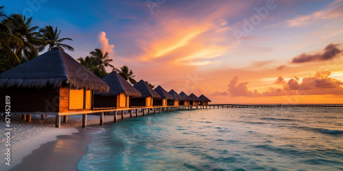 Tropical beach panorama view, Caribbean sea under sunset light, summer evening time, Tropical seascape with Bungalows, turquoise sea and white sand. Background of summer beach.