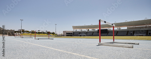 Stadium, hurdles and sports event for exercise, olympics and training with no people, space and mockup. Sport, venue and hurdling workout at an empty track for workout, healthy lifestyle and venue photo