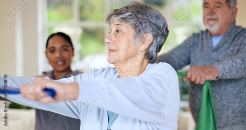 Rehabilitation, recovery or resistance band and a senior people in their home with a personal trainer. Fitness, physiotherapy or health with an elderly man and woman in their apartment for a workout © Charlize D/peopleimages.com