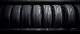 New beautiful tires pile on a warehouse background for car tire service and tire change season. Tire fitting background with stack of car tires. Copy space. Generative ai