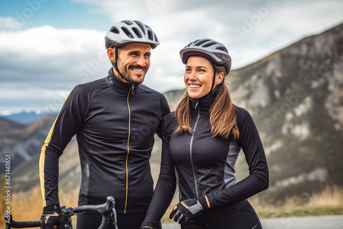 Woman and man on cycling road taking a break from drive with helmet and cycling gear on, active sport life with your spouse