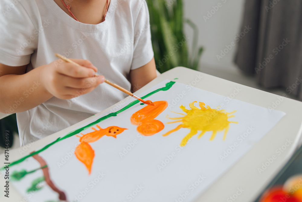 A cute boy draws with paints. Children draw in their free time A cute boy draws with paints. Children draw in their free time