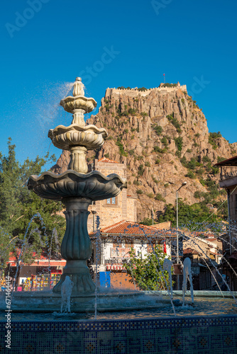 Traditional Afyonkarahisar houses, ornamental pool and Afyon Castle in Afyonkarahisar Turkey