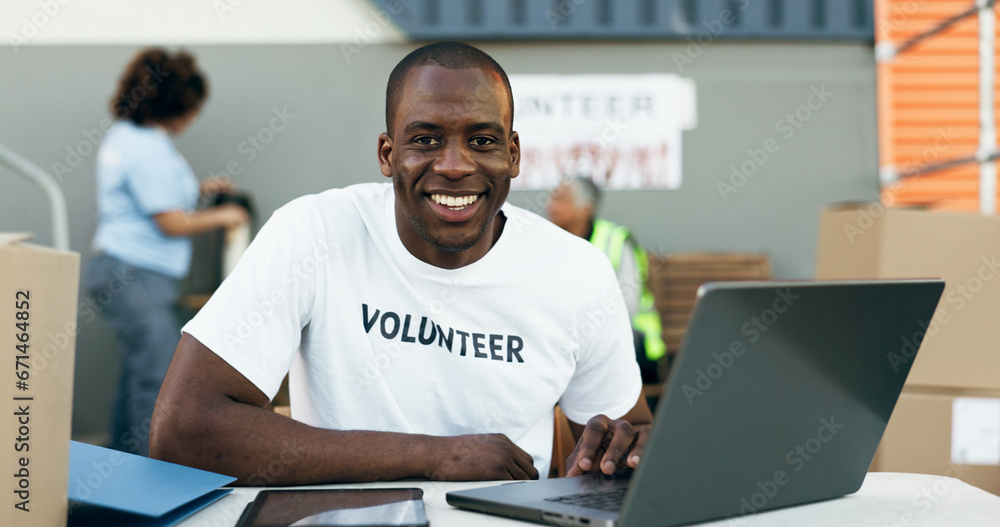 Volunteer man, laptop and portrait for donation, clothes drive and smile for community service, scroll and web. African person, pc and social responsibility with boxes, charity and ideas for helping Volunteer man, laptop and portrait for donation, clothes drive and smile for community service, scroll and web. African person, pc and social responsibility with boxes, charity and ideas for helping