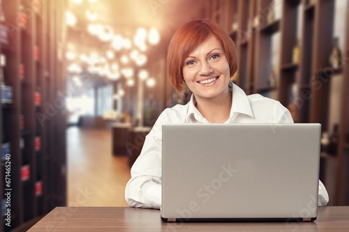 Positive businesswoman typing on the laptop.
