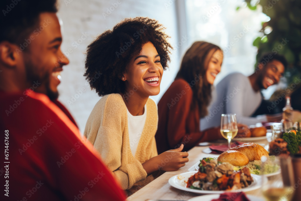 African American family having dinner during thanksgiving day. Happy people celebrating holiday, eating and laughing together African American family having dinner during thanksgiving day. Happy people celebrating holiday, eating and laughing together