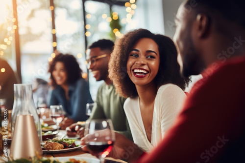 African American family having dinner during thanksgiving day. Happy people celebrating holiday  eating and laughing together